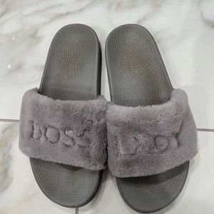 Furry grey slides that say Boss Lady